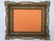 Antique frame painted gold on a orange background