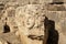 Antique frieze with stone-cut mask in the ruins of the ancient city of Myra, Turkey