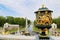 Antique gilded vase on the background of a Large cascade on a clear sunny day