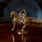 Antique gold figurine of a horse in a luxurious interior.