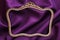 Antique golden photo frame, purple fabric