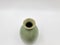 Antique green pottery Sake Bottle in white background for decoration and collectible
