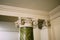 Antique green veined marble column supporting the ceiling