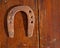 Antique horseshoe luck symbol rusted on vintage wood