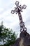 Antique iron cross on tombstone, France cemetery