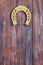 Antique Iron Gold Rusty Horseshoe Hanging on a Wooden Plank Door. 3d Rendering