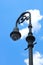 Antique lamppost in front of soft blue sky`s in historic Savannah Georgia