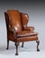 Antique leather wing chair carved legs