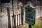 An antique mail box with an embossed figurine of a messenger pigeon, covered with spider webs. Translation of `mail` in