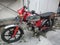 antique male motorbike, red silver color that is old but still roadworthy