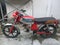 antique male motorbike, red silver color that is old but still roadworthy