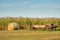 An antique manure spreader and a round bale of hay