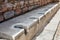 Antique marble public toilet in the city of Ephesus, Turkey