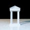 Antique marble temple front with ionic columns on marble
