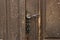 Antique metal door handle on old wooden doors. Vintage iron door knob