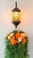 Antique metal lamp, Classic lantern decorated with a bunch of classic flower bouquets. White bricks background