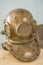 Antique metal scuba helmet, heavy diving equipment with air supp