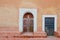 Antique Moroccan doors against old orange pink wall.