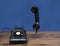 Antique old rotary dial telephone on wooden desk