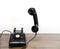 Antique old rotary dial telephone on wooden desk