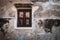 Antique old window on loft industrial grunge exterior wall. Old brick walls and window