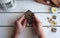 Antique pendant in the girl hands on a white background wooden