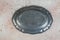 Antique pewter oval plate on concrete background