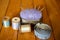 Antique Pin Cushion with Wooden Spools of Thread and Measuring Tape on Wooden Planks