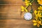 Antique pocket watch with yellow gardenia flower on wooden background