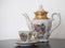 Antique porcelain teapot with cup and saucer