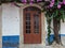 Antique Portuguese Architecture: Old Brown Door near Vegetation in Obidos Main Street - Portugal