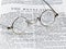 Antique reading glasses on page of bible