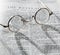 Antique reading glasses on page of bible