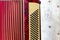 Antique red 120 bass accordion.covered with dust on wooden construction background