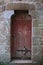 Antique red distressed door with rusty iron work stone frame beautiful european travel