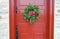 Antique red door with wreath