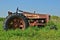 Antique Red Tractor Parked in Grass