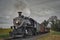 Antique Restored Steam Freight Train Approaching Head on Blowing Smoke and Steam