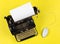 Antique retro mechanical typewriter with modern computer mouse on yellow background - digitalization, digitization or