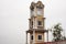 Antique retro vintage building clock tower in Local Talad Nam Floating Market of  Wat Bot Bon temple for thai people travelers