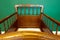 Antique retro wooden baby crib in babies room with green walls modern interior