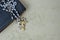 Antique rosary and prayer book on marbled paper background