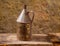 Antique rusted iron jar with aged brass on vintage wood
