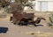 Antique rusted out automobile body on wooden blocks on an empty lot in Marfa, Texas.