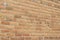 Antique sandy brown clay brick wall texture with a weathered and worn look