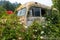 Antique school bus overgrown by weeds in a junkyard in Idaho, USA