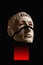 Antique sculpture of human face surreal collage in pop art style. Modern image with cut details of statue head. Red eyes