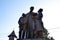 An antique sculpture of Saint John Bosco, Don Bosco with street children