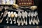 Antique silver Cutlery, spoons, forks, knives on the shelf of the flea market