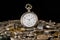 Antique silver pocket watch among clockwork parts on black isolated studio background. Gears, cogwheels, old metal